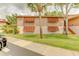 A condo exterior with shuttered windows, well-maintained landscaping, and a sidewalk at 150 Wax Myrtle Woods Ct # 3D, Deltona, FL 32725