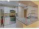 Modern kitchen with white cabinets, stainless steel appliances, and granite countertops at 150 Wax Myrtle Woods Ct # 3D, Deltona, FL 32725