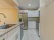Updated kitchen featuring stainless steel appliances, white cabinets, and granite countertops at 150 Wax Myrtle Woods Ct # 3D, Deltona, FL 32725