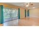 Open living area with hardwood floors, bright walls, ceiling fan, and sliding glass door to the screened patio at 150 Wax Myrtle Woods Ct # 3D, Deltona, FL 32725