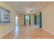 Sunlit living room with hardwood floors, ceiling fan, neutral walls, and sliding glass doors to the patio at 150 Wax Myrtle Woods Ct # 3D, Deltona, FL 32725