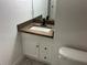 Modern bathroom vanity features a dark wood counter with a square white sink and black faucet at 1501 Delaware Ave, St Cloud, FL 34769