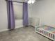 Bright bedroom with large window, gray tile floors, lilac curtains, and white dresser at 1501 Delaware Ave, St Cloud, FL 34769