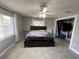 Bedroom with gray walls, ceiling fan, tile floors, and large closet with sliding doors at 1501 Delaware Ave, St Cloud, FL 34769