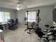 Spacious bonus room with a computer desk, weight rack, and drum set at 1501 Delaware Ave, St Cloud, FL 34769