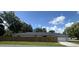 Exterior shot of the home showcasing the roof and wooden privacy fence at 1501 Delaware Ave, St Cloud, FL 34769
