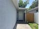 Close-up of the front door, highlighting the entrance and adjacent wooden fence at 1501 Delaware Ave, St Cloud, FL 34769