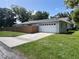 Attached two-car garage, showcasing ample parking and a well-kept exterior at 1501 Delaware Ave, St Cloud, FL 34769