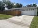 Spacious two-car garage with an adjacent wooden fence for privacy at 1501 Delaware Ave, St Cloud, FL 34769