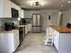 Bright kitchen featuring white cabinets, stainless steel appliances, and butcher block countertops at 1501 Delaware Ave, St Cloud, FL 34769