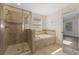 Bathroom showcasing glass shower, large soaking tub and tiled walls at 15229 Evergreen Oak Loop, Winter Garden, FL 34787