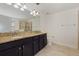 Spacious bathroom with double vanity, granite countertop and large mirror at 15229 Evergreen Oak Loop, Winter Garden, FL 34787