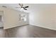 Neutral bedroom with gray floors, ceiling fan, and a door leading outside at 15229 Evergreen Oak Loop, Winter Garden, FL 34787
