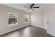 Comfortable bedroom featuring hardwood floors, large windows, and natural light at 15229 Evergreen Oak Loop, Winter Garden, FL 34787