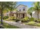 Charming two-story home featuring stone accents, a landscaped yard, and a welcoming covered front porch at 15229 Evergreen Oak Loop, Winter Garden, FL 34787