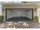 Attached two-car garage with an epoxy floor and plenty of room for parking and storage at 15229 Evergreen Oak Loop, Winter Garden, FL 34787