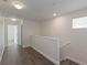 Upstairs hallway with hardwood floors, neutral walls, and natural light at 15229 Evergreen Oak Loop, Winter Garden, FL 34787