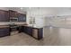 Contemporary kitchen with stainless steel appliances, dark cabinetry, and an open layout into the living room at 15229 Evergreen Oak Loop, Winter Garden, FL 34787