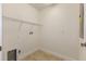 This laundry room has tiled floors, wire shelving and washer and dryer hookups for convenience at 15229 Evergreen Oak Loop, Winter Garden, FL 34787