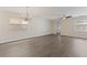 Spacious living room with gray wood floors, a chandelier, a ceiling fan, and plenty of natural light at 15229 Evergreen Oak Loop, Winter Garden, FL 34787