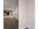 Open-concept living room features hardwood floors and a view of the gourmet kitchen with modern appliances at 15229 Evergreen Oak Loop, Winter Garden, FL 34787
