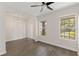 Bright living room with gray wood floors, two large windows for natural light, and recessed lighting at 15229 Evergreen Oak Loop, Winter Garden, FL 34787