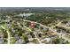 Aerial view showing the neighborhood, mature landscaping and proximity to a lake at 1591 Pendleton St, Deltona, FL 32725