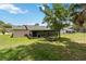 The exterior of the backyard with a lanai for relaxing and entertaining at 1591 Pendleton St, Deltona, FL 32725