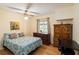 Bedroom with ceiling fan, wood floors and an alcove desk area at 1591 Pendleton St, Deltona, FL 32725