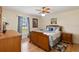 Cozy bedroom featuring a ceiling fan, wood flooring, and a window with natural light at 1591 Pendleton St, Deltona, FL 32725