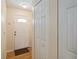 Bright entryway featuring a white front door with glass detail and wood flooring at 1591 Pendleton St, Deltona, FL 32725
