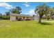 Inviting single-story home with a lush green lawn, mature landscaping, and a sunny curb appeal at 1591 Pendleton St, Deltona, FL 32725
