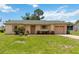 Well-maintained single-story home boasting a neat lawn, tidy landscaping, and an attached garage at 1591 Pendleton St, Deltona, FL 32725