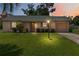 Charming single-story home featuring a well-manicured lawn and a cozy, inviting entrance at 1591 Pendleton St, Deltona, FL 32725
