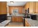 Well-equipped kitchen with granite countertops, stainless steel appliances, and wood cabinetry at 1591 Pendleton St, Deltona, FL 32725