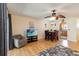 Bright living room with adjacent dining area, featuring wood floors and neutral tones at 1591 Pendleton St, Deltona, FL 32725