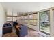 Bright sunroom with tiled floors, multiple windows, and comfortable seating at 1591 Pendleton St, Deltona, FL 32725