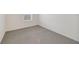 This carpeted bedroom with a neutral color scheme offers a calming space at 1689 Greenleaf Woods Cv, Oviedo, FL 32765