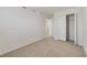 Carpeted bedroom features an open closet and plenty of empty space at 1689 Greenleaf Woods Cv, Oviedo, FL 32765