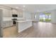 A bright, spacious kitchen with stainless steel appliances, center island, and sliding door to the backyard at 1689 Greenleaf Woods Cv, Oviedo, FL 32765
