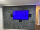 A media room featuring a stylish reclaimed wood accent wall with mounted television at 170 N Fairfax Ave, Winter Springs, FL 32708