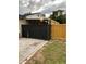 View of the backyard featuring the corner of a newly stained black and stained wooden fence at 170 N Fairfax Ave, Winter Springs, FL 32708