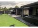 Entertain outdoors with a pool table and wet bar on the covered patio, surrounded by lush green grass at 170 N Fairfax Ave, Winter Springs, FL 32708