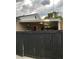 View of the backyard featuring a large covered patio and a newly stained dark privacy fence at 170 N Fairfax Ave, Winter Springs, FL 32708