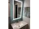 Updated bathroom with modern vanity, backlit mirror and attractive seaside themed decor at 170 N Fairfax Ave, Winter Springs, FL 32708