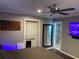 Bedroom features a door to the backyard, TV, and ensuite bathroom at 170 N Fairfax Ave, Winter Springs, FL 32708