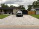 Driveway with paver stones on a home with light colored exterior and dark roof, black fence in back at 170 N Fairfax Ave, Winter Springs, FL 32708