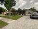 Exterior view of the charming home featuring brick paver driveway, landscaping, and inviting front entrance at 170 N Fairfax Ave, Winter Springs, FL 32708