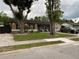 Charming single story home with a lawn, mature trees, dark shutters, and outdoor seating area on the front porch at 170 N Fairfax Ave, Winter Springs, FL 32708