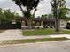 Charming single story home with a lawn, mature trees, dark shutters, and outdoor seating area on the front porch at 170 N Fairfax Ave, Winter Springs, FL 32708